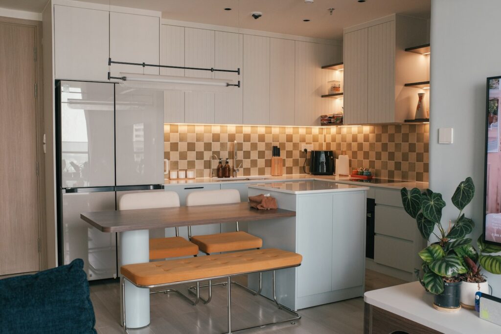 A living room and kitchen with a flat screen TV