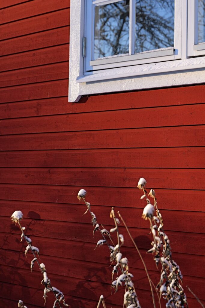 A red house with a white window and white trim