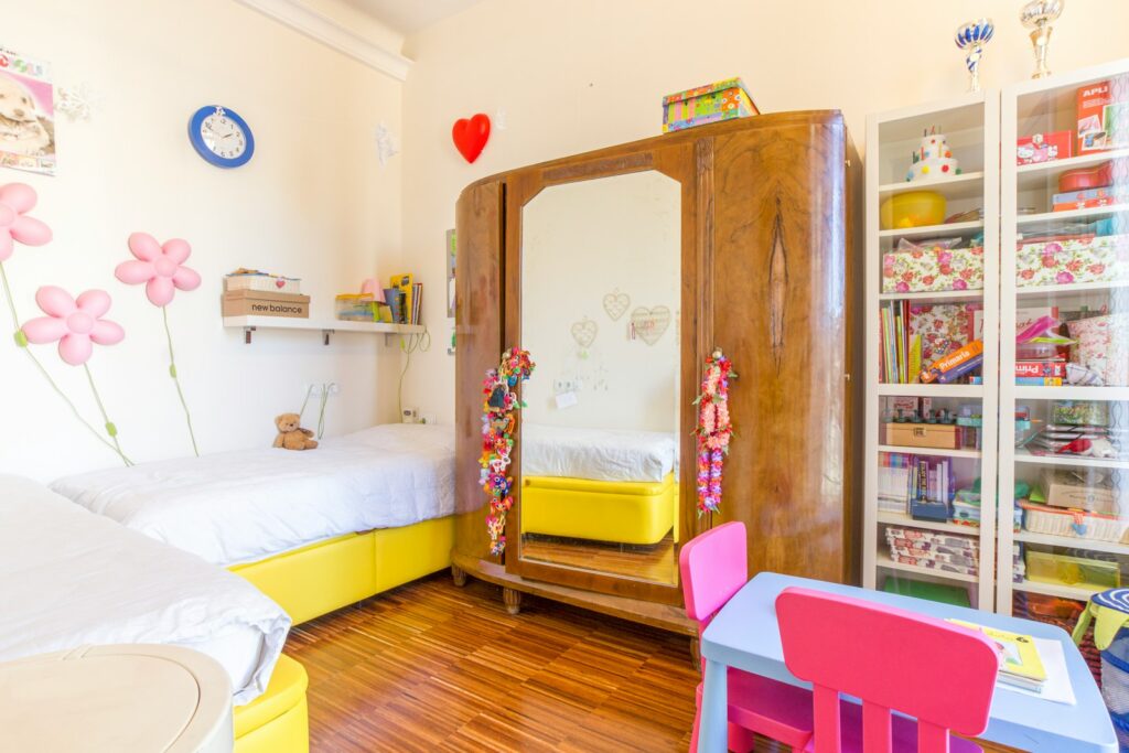 brown wooden cabinet beside white bed